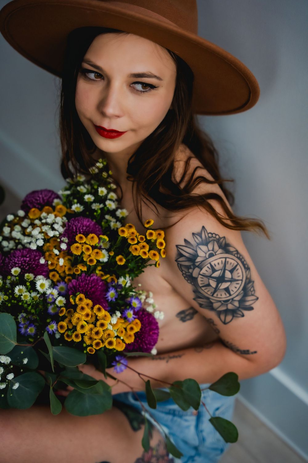 Celebrate natural beauty with bohemian boudoir; denim, wildflowers, and romantic charm for a self-love journey.
