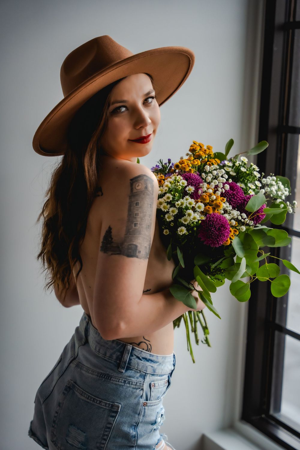 Celebrate natural beauty with bohemian boudoir; denim, wildflowers, and romantic charm for a self-love journey.