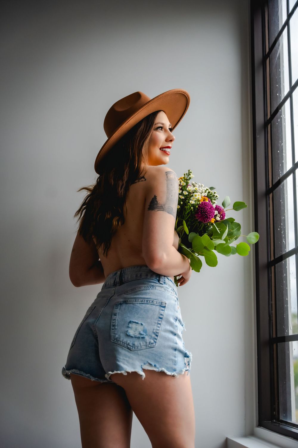 Celebrate natural beauty with bohemian boudoir; denim, wildflowers, and romantic charm for a self-love journey.