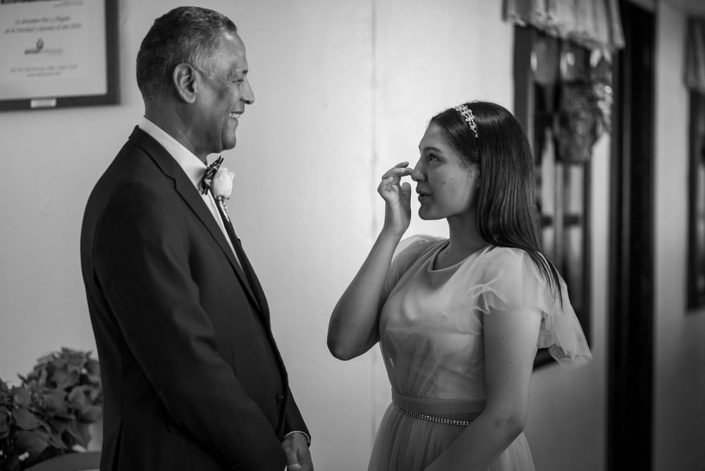 A tearful bride shares an intimate moment with her father before the wedding ceremony.