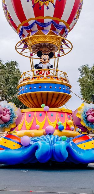 Multiple colorful decorative elements from a Disney parade float featuring vibrant blue waves and festive designs.