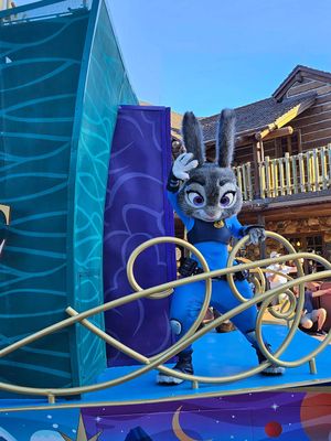 A sequence of images showing a blue animatronic butterfly unfurling and moving its wings in a colorful display setting.