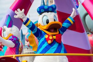 A colorful display of Disney character figurines at a theme park or merchandise shop featuring cartoon figures.