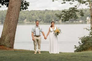 Romantic lakeside wedding portraits with natural scenery and water views.
