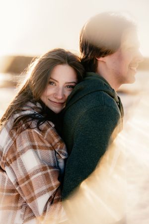 Intimate winter portrait session with warm golden sunlight.