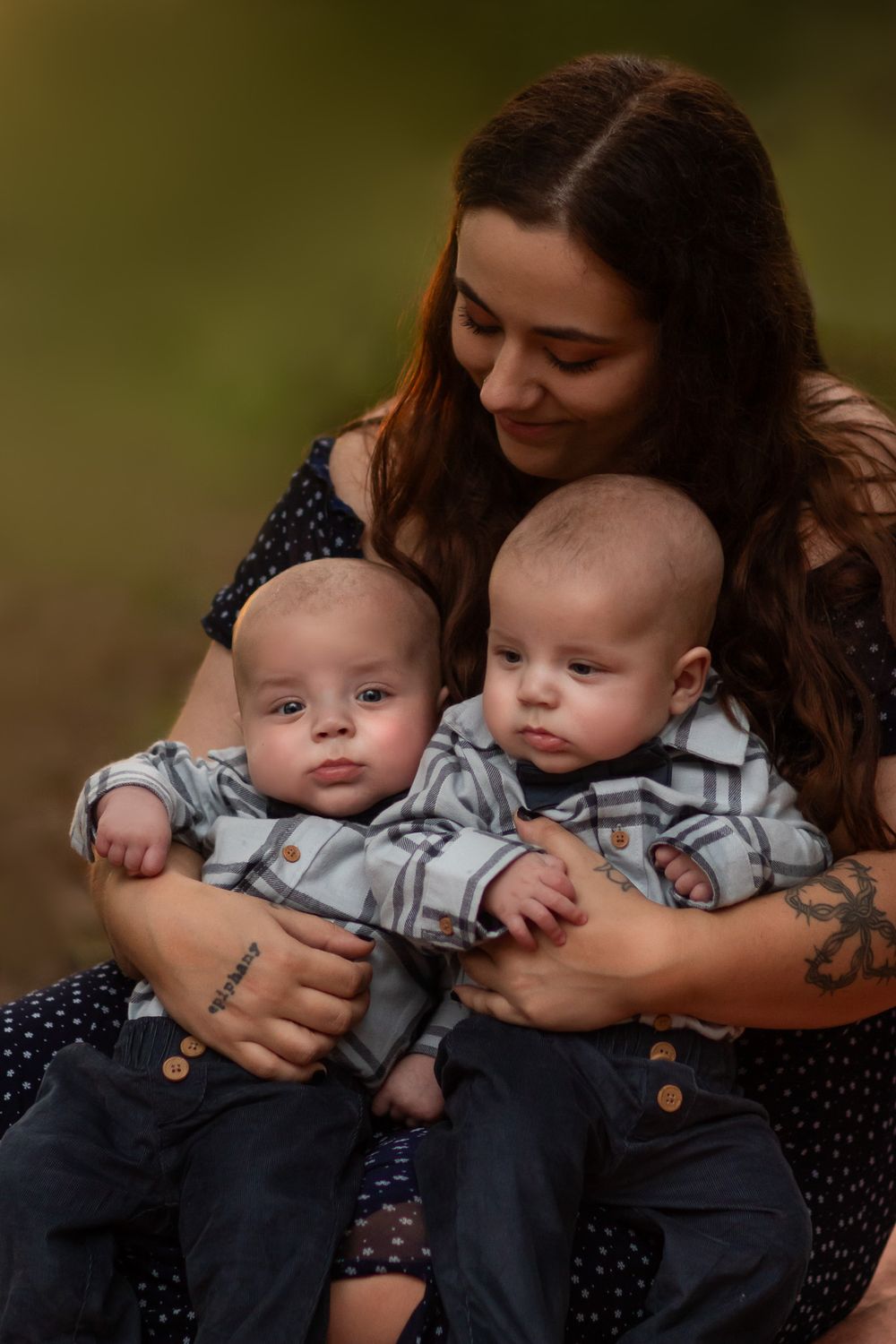 Twin baby boys being held by mom during family photoshoot in Joplin, Missouri. Captured by Joplin family photographer.