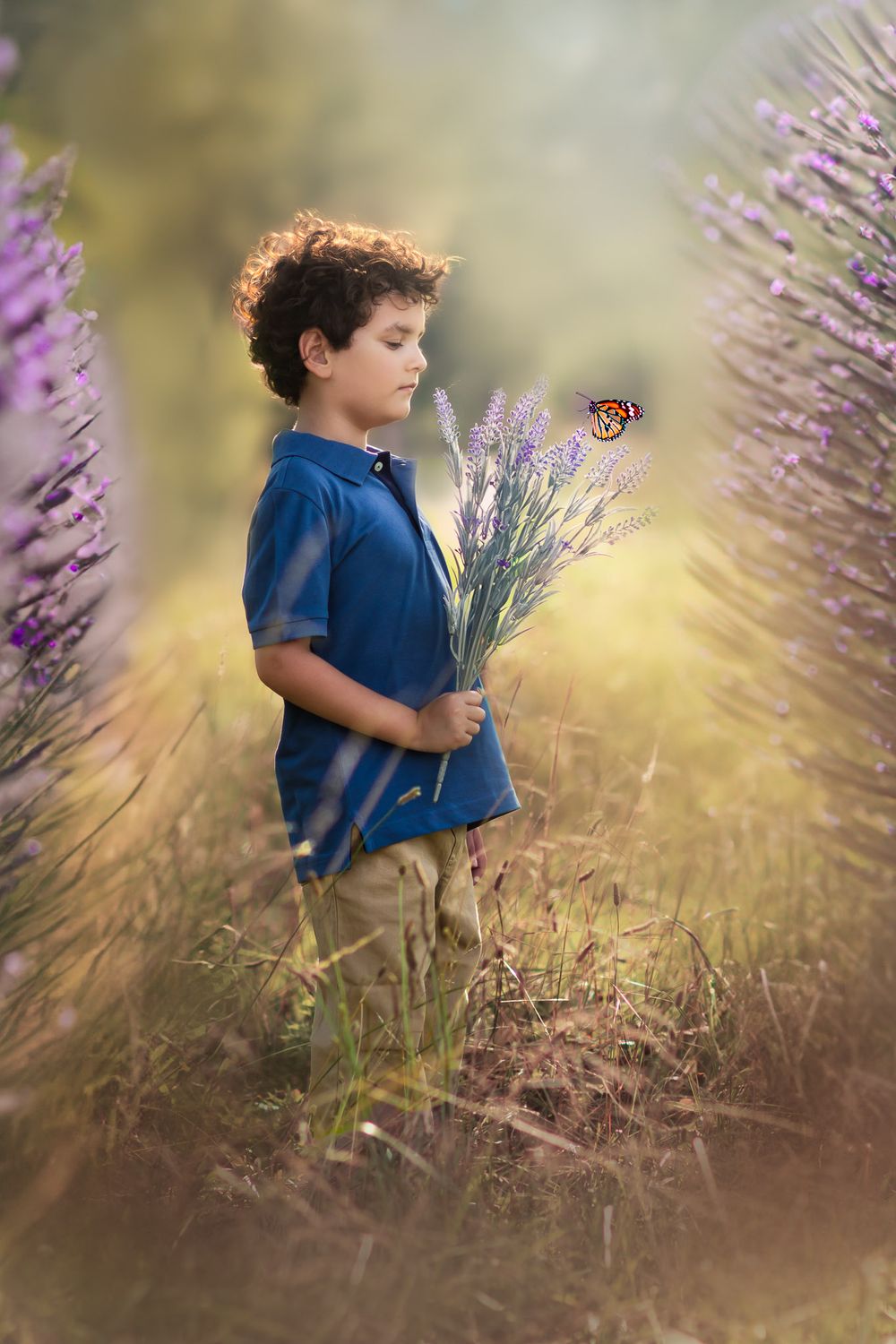 Boy holding flowers in a Galena field during a family photoshoot, captured by Joplin family photographer.
