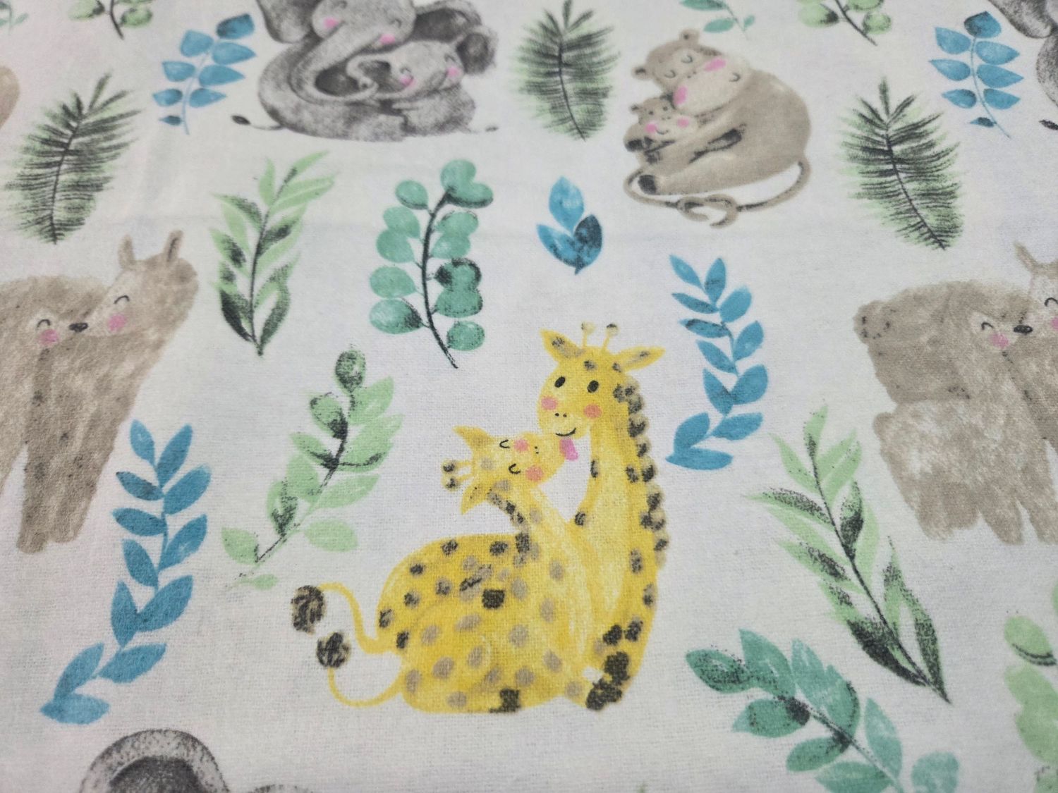 Whimsical watercolor pattern featuring yellow cheetahs, gray bunnies, and blue and green botanical elements on white background.