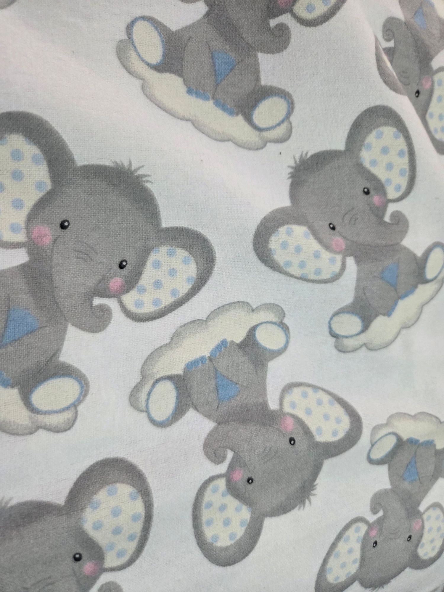 Cute gray cartoon elephants with polka dot patterns form a seamless repeating pattern on light background.
