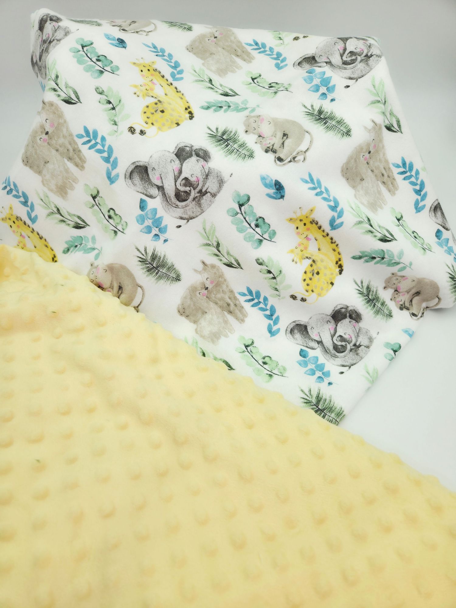 Soft minky baby blanket with elephant and giraffe pattern shown from multiple angles on white background.