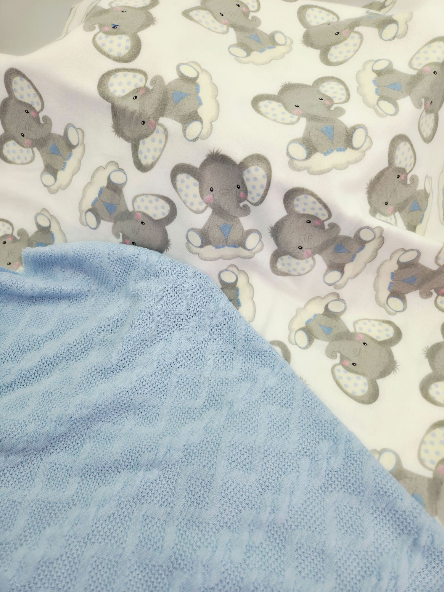 A series of images showing a baby blanket with gray elephant print pattern transitioning to light blue mesh fabric.
