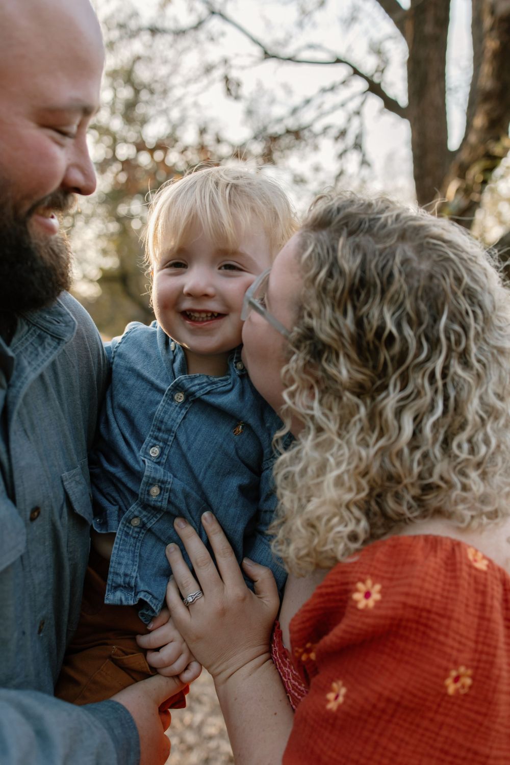 Joyful family moment captured outdoors during golden hour.