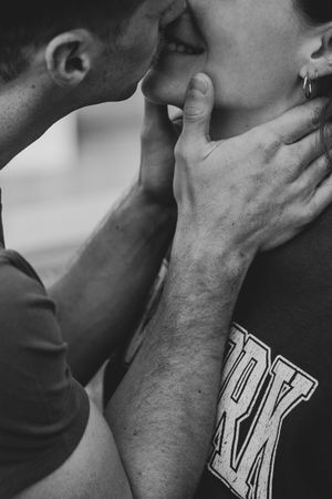 A dramatic black and white close-up of an intimate moment between two people.