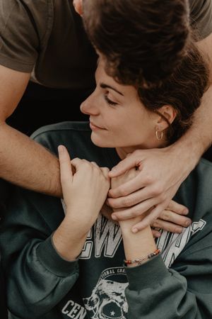 A tender moment captured in warm tones showing gentle hands and intimate connection.