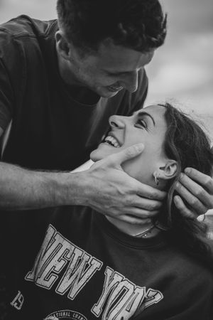 Black and white series of intimate couple portraits showing tender kisses and embraces while wearing casual clothing.