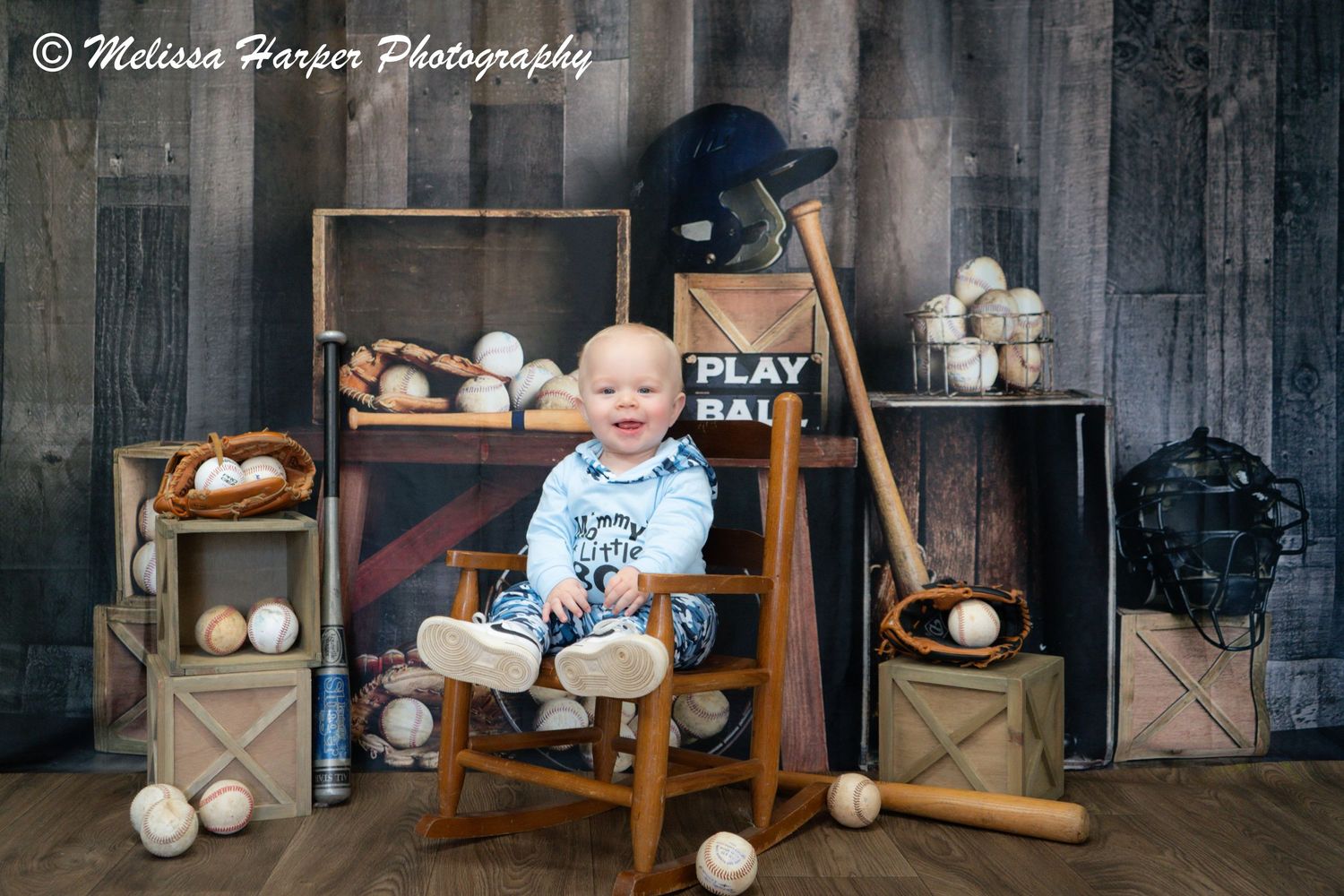 Rustic baseball themed photo setup with wooden crates and baseballs.