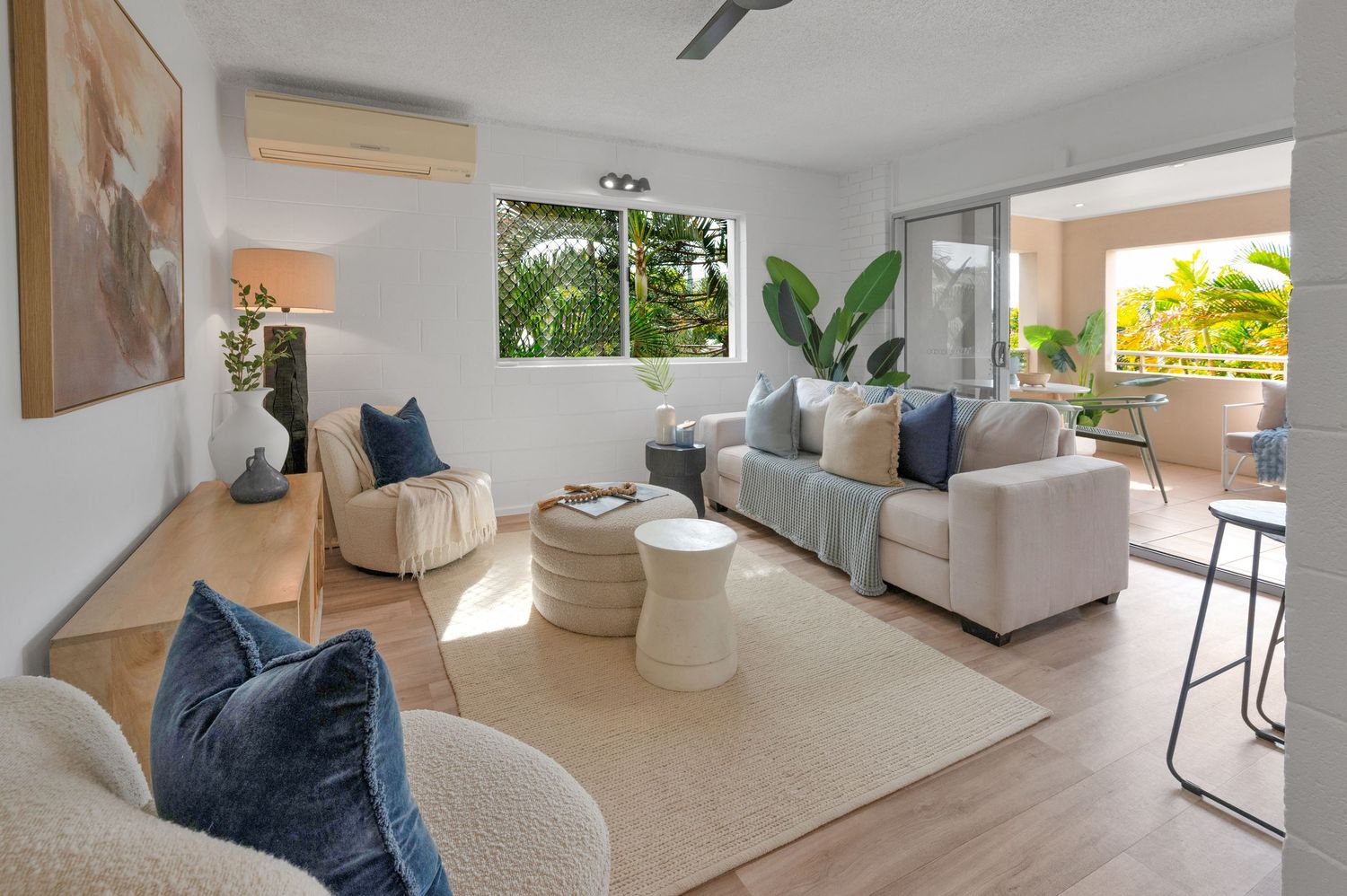 Bright modern living room interior with white walls and contemporary furnishings.