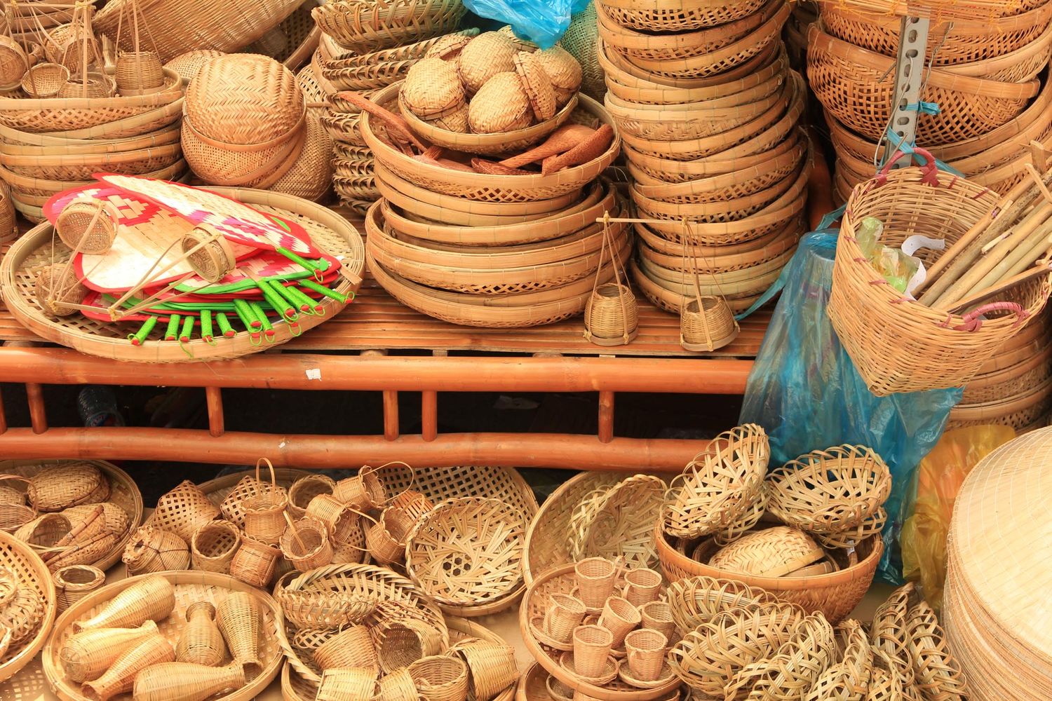 Traditional handmade woven baskets and bowls made from natural materials displayed at a local artisan market.