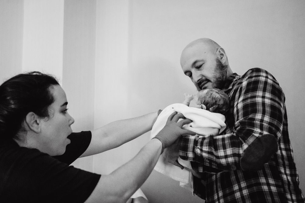Emotional black and white hospital scene showing birth support and care.