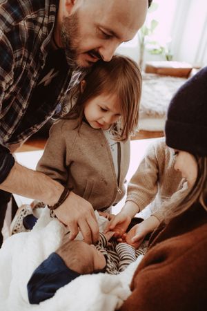 Close-up view of caring hands holding and comforting a young infant.
