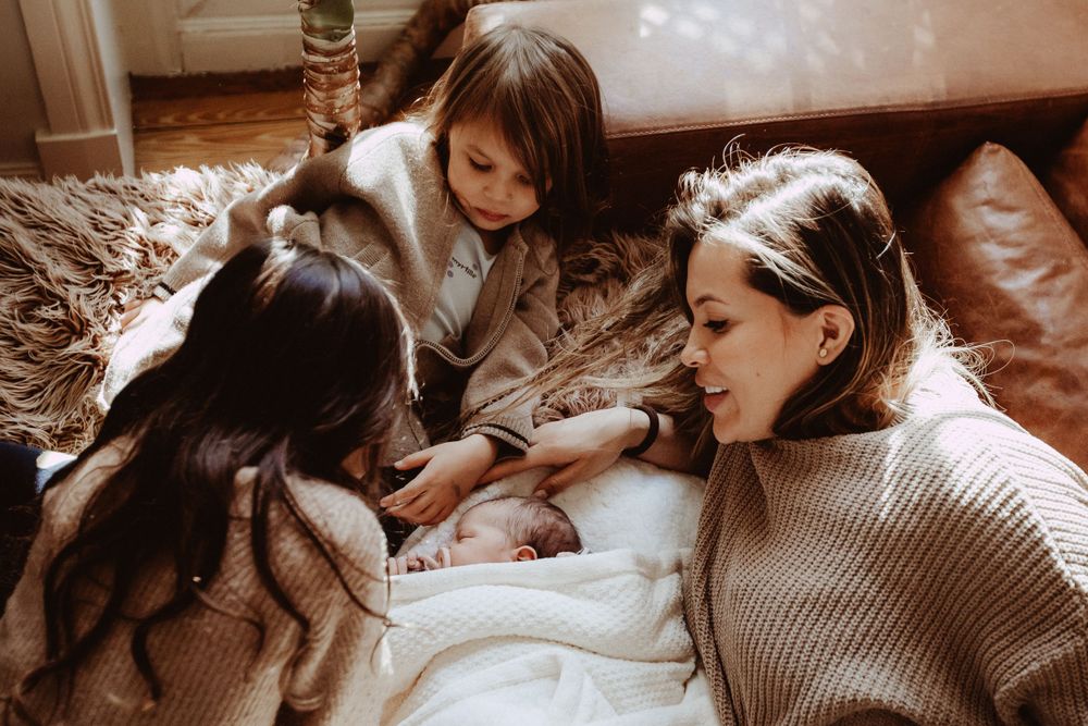 Quiet moment of connection between caregiver and infant in natural light.
