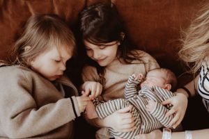 Gentle bonding moment with a baby wearing striped clothing.