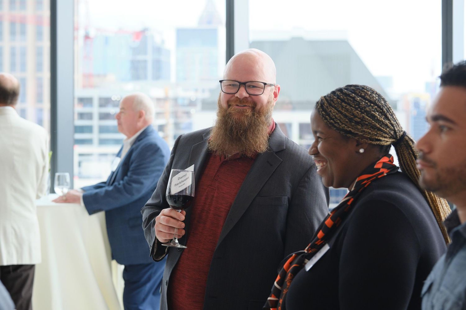 Attendees engaging in conversation at professional networking reception.