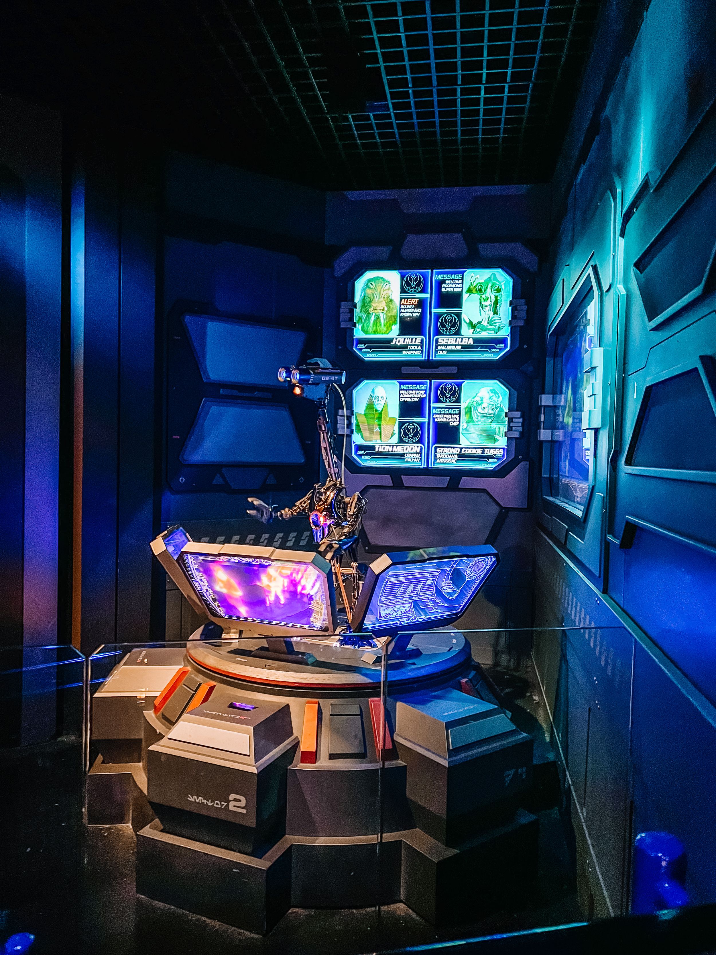 Futuristic sci-fi control room with glowing blue displays and neon accents in a cyberpunk-style spaceship interior.