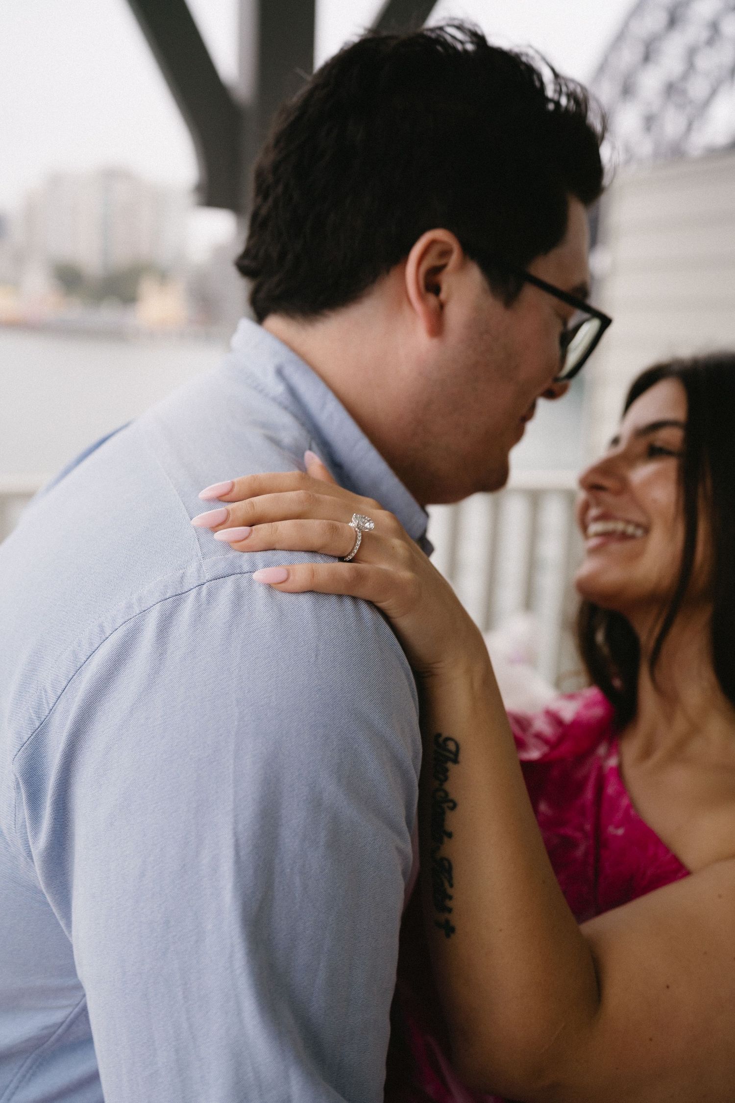 A close-up shot shows a tender moment between a couple with an engagement ring visible.