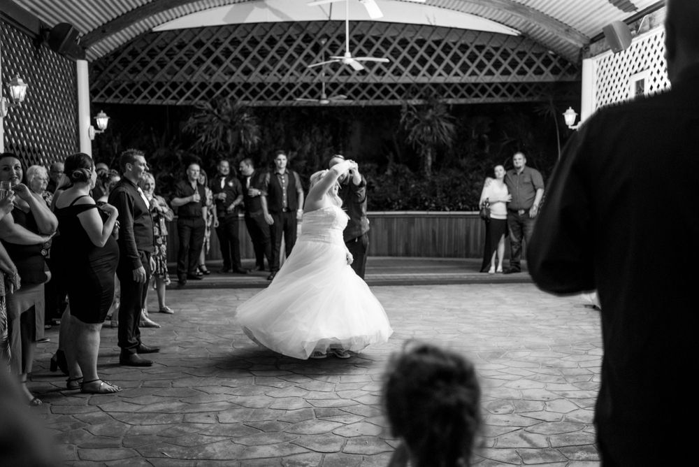 Wedding dress twirling during a dance in an indoor venue with watching guests. Yoho National Park
