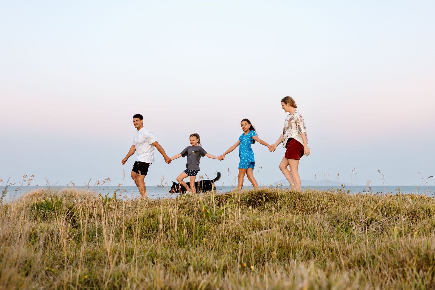Family fun Portrait on sand dunes at the beach.