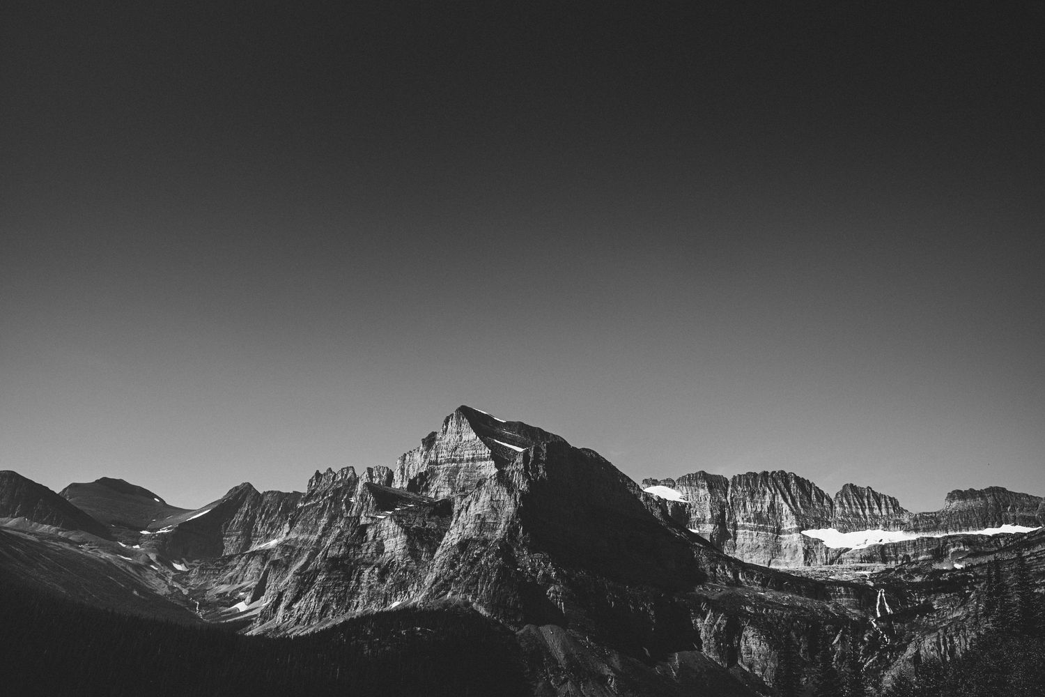 Dramatic black and white mountain peaks against a gradient sky.