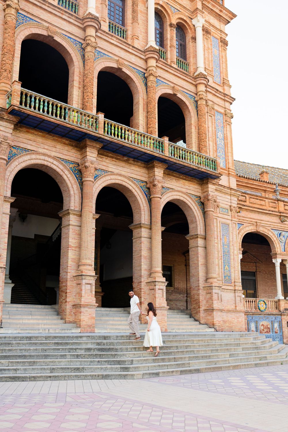 Majestic colonnade and steps at Plaza de España showcasing classic Spanish Renaissance architecture.