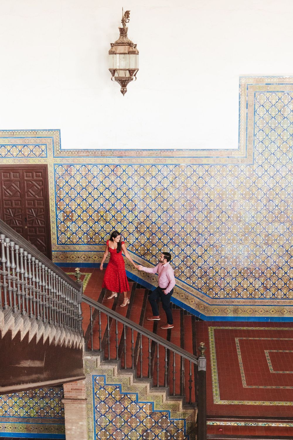 Ornate tiled staircase with geometric patterns and colorful mosaics at Plaza de España in Seville.