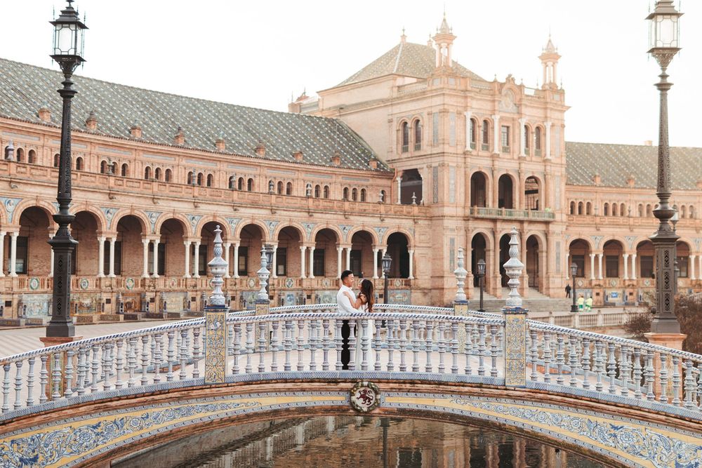 Panoramic view of Plaza de España's bridges and architecture in golden evening light.