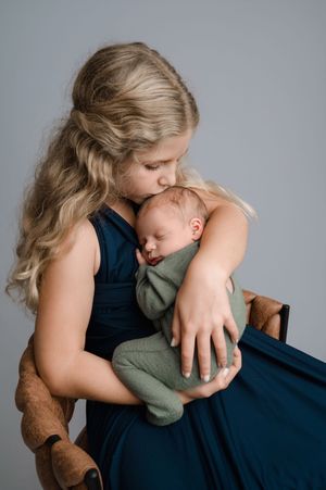 A series of intimate photos showing tender moments between parent and child in a minimalist studio setting.
