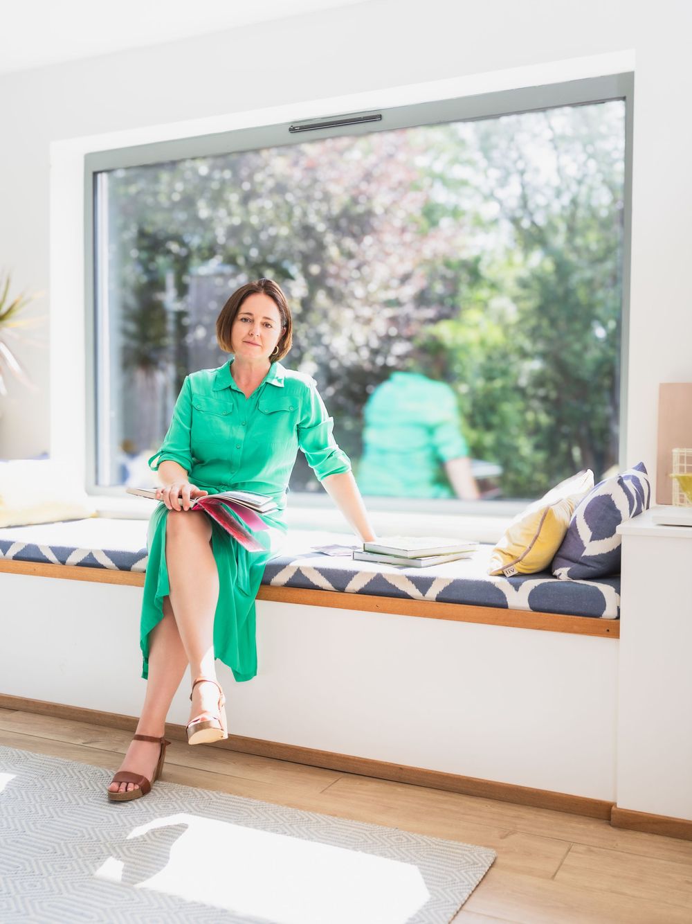 Personal branding portrait of Kate Cotterill seated by a window at her home in Harkstead, Suffolk
