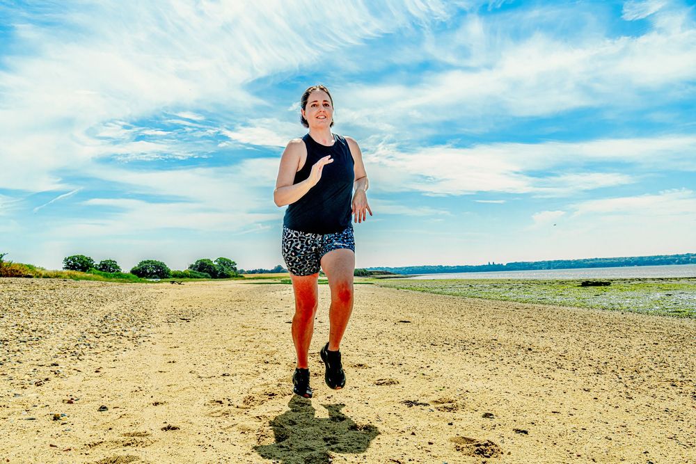 Kate Cotterill, Lifestyle editorial branding portrait of her running along the Suffolk estuary at Holbrook.