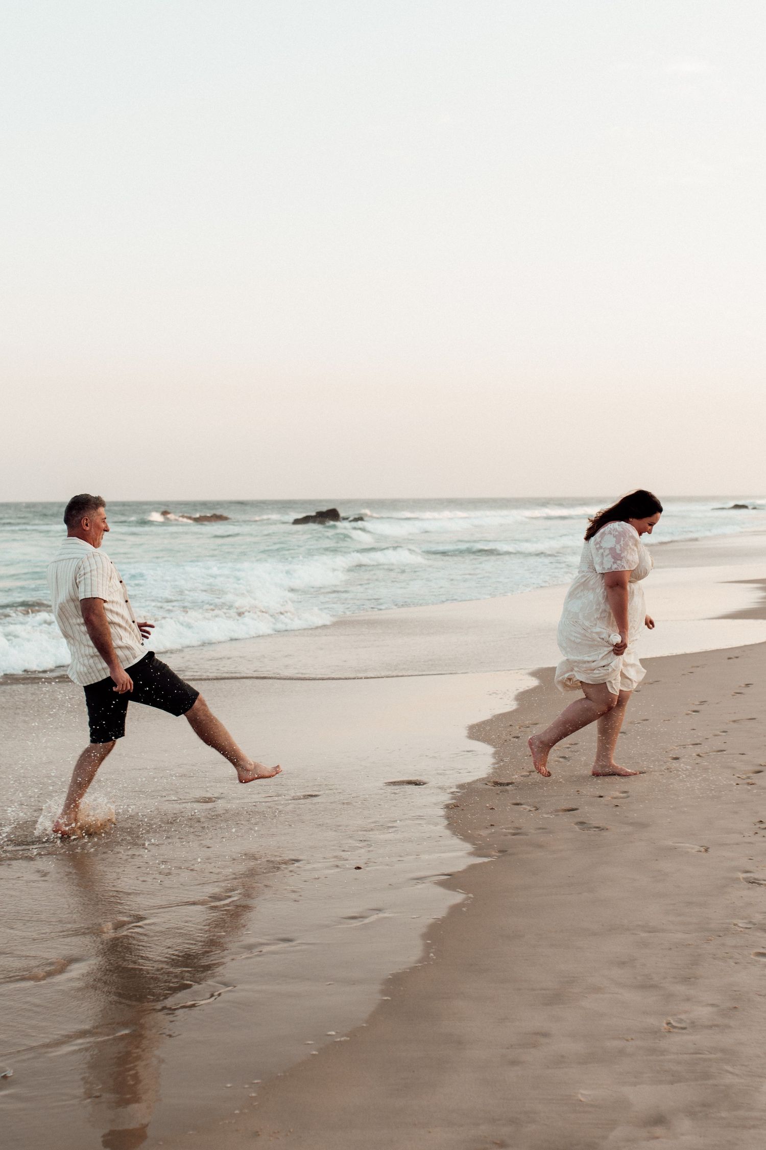 A sequence of photos showing someone running and splashing playfully along the ocean shoreline at sunset.