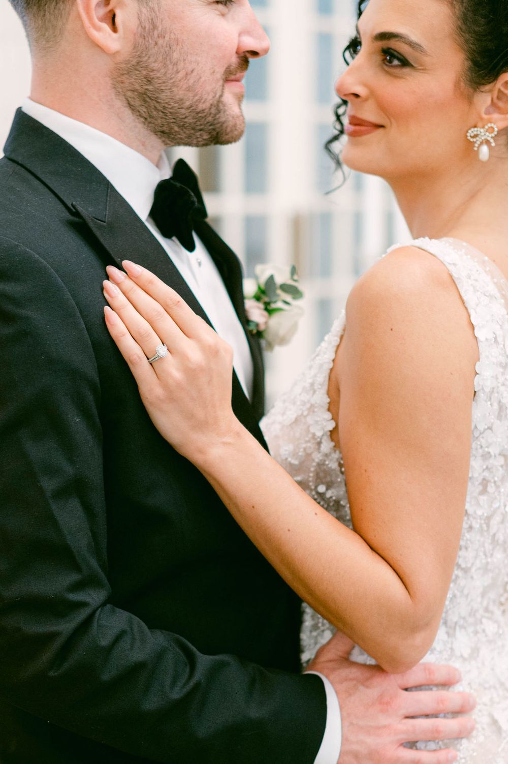 Close-up of couple in formal wedding attire sharing an intimate moment.