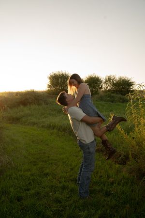 Playful scene in a meadow with dramatic sunset lighting and natural foliage.