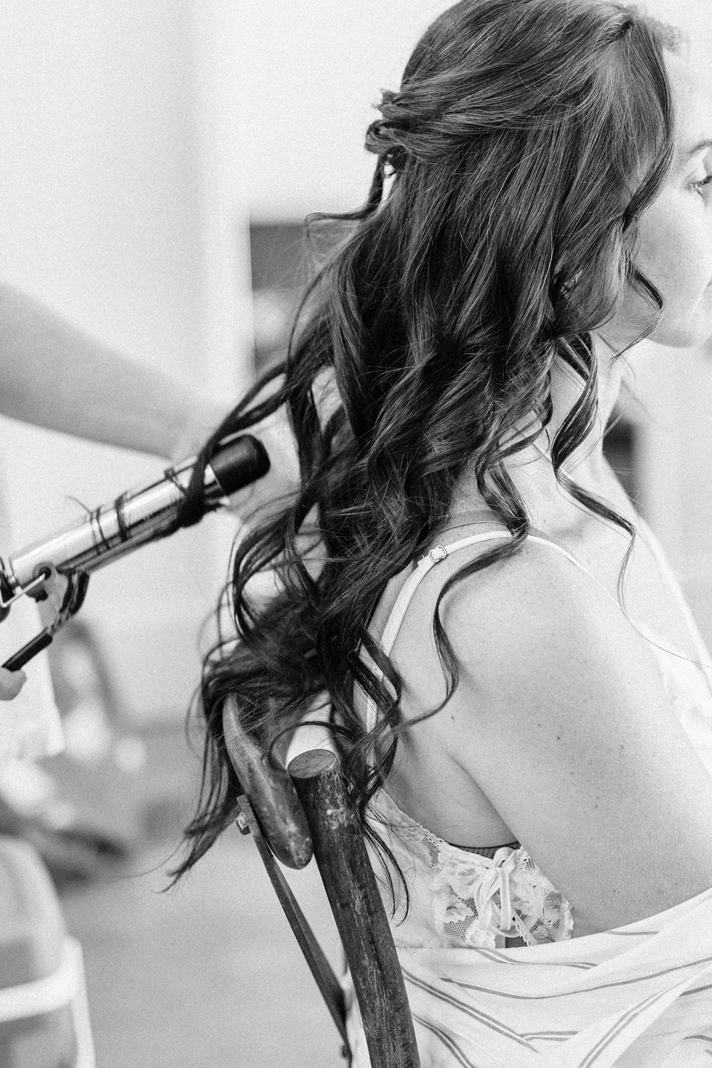 Close-up black and white photo series showing cascading brunette curls being styled with a curling iron.