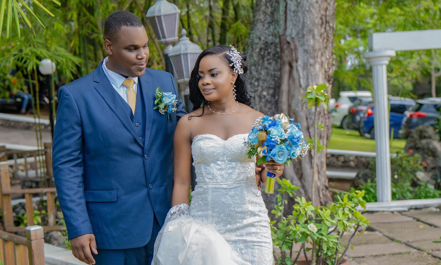 Wedding portraits on garden path with white picket fence and palm trees. Kelly Photography Atlanta Wedding Session, Ochi Jamaica.