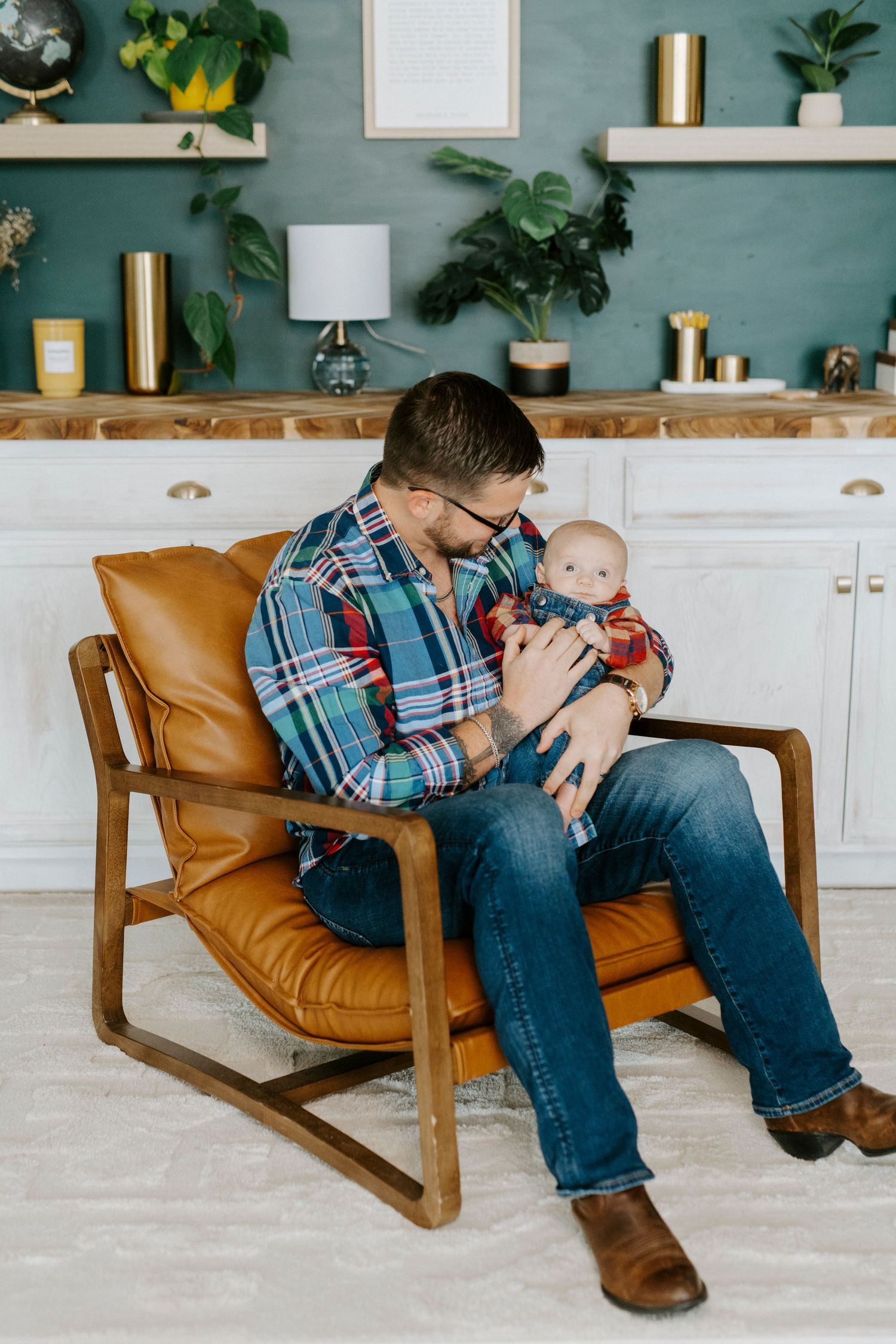 A series of photos showing a parent and baby bonding together on a brown leather chair in a modern living room setting.