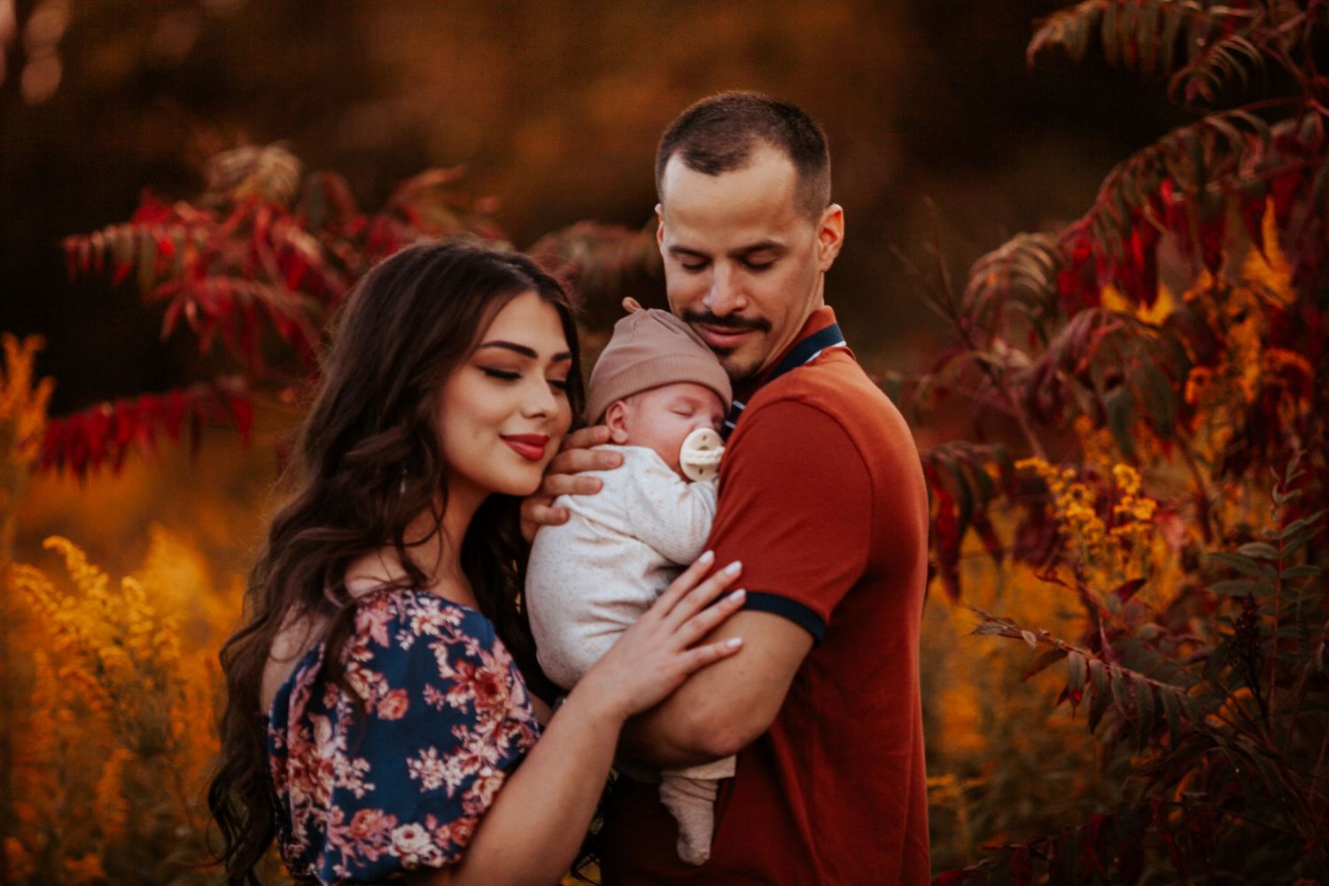 A romantic autumn photo shoot with warm orange foliage in the background.