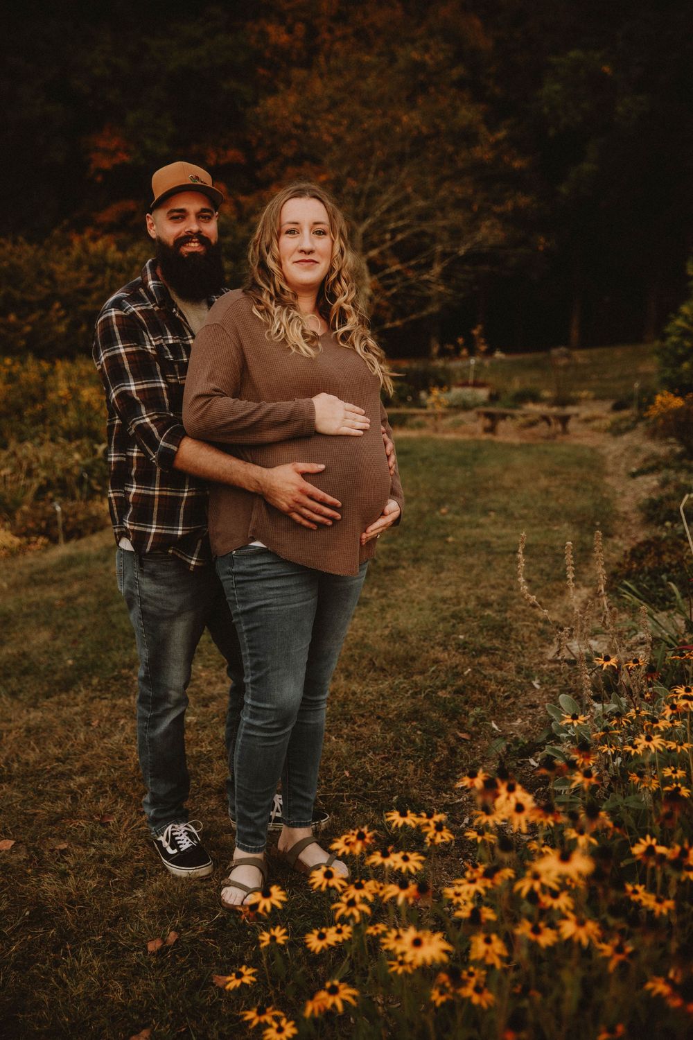 Couple shares intimate autumn maternity photo shoot in field with golden wildflowers at sunset. indiana pa photographer blue spruce park