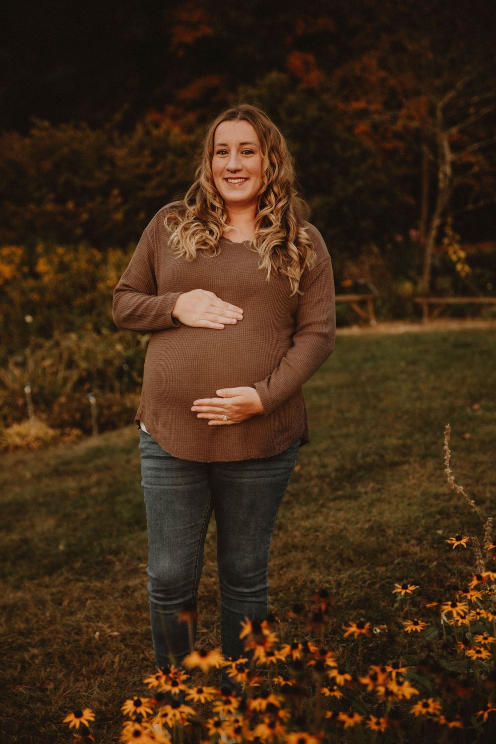 Couple shares intimate autumn maternity photo shoot in field with golden wildflowers at sunset. indiana pa photographer blue spruce park