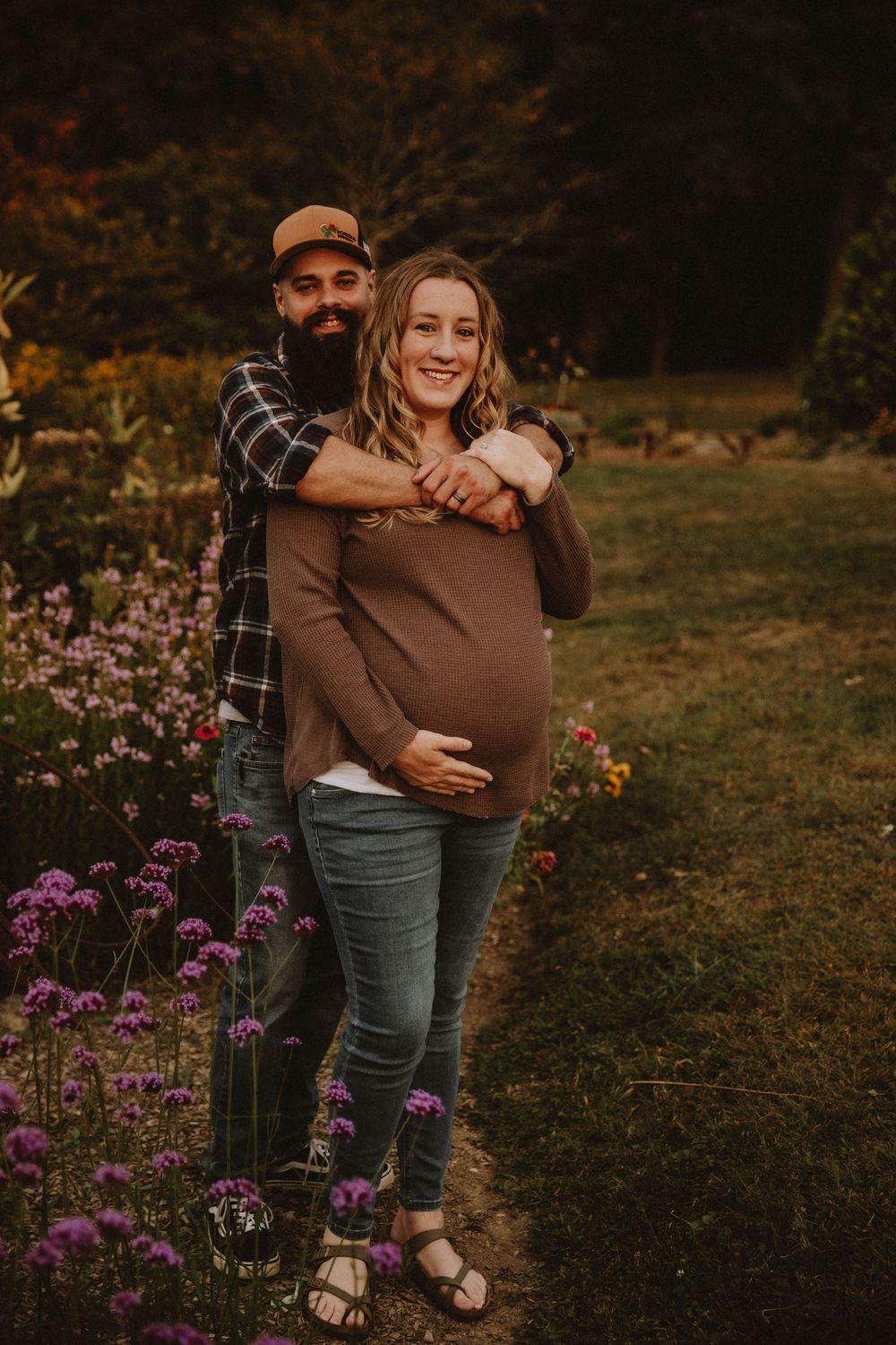 Couple shares intimate autumn maternity photo shoot in field with golden wildflowers at sunset. indiana pa photographer blue spruce park