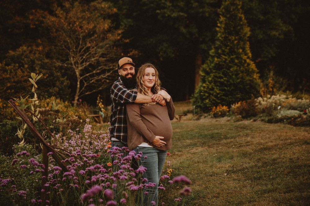 Couple shares intimate autumn maternity photo shoot in field with golden wildflowers at sunset. indiana pa photographer blue spruce park