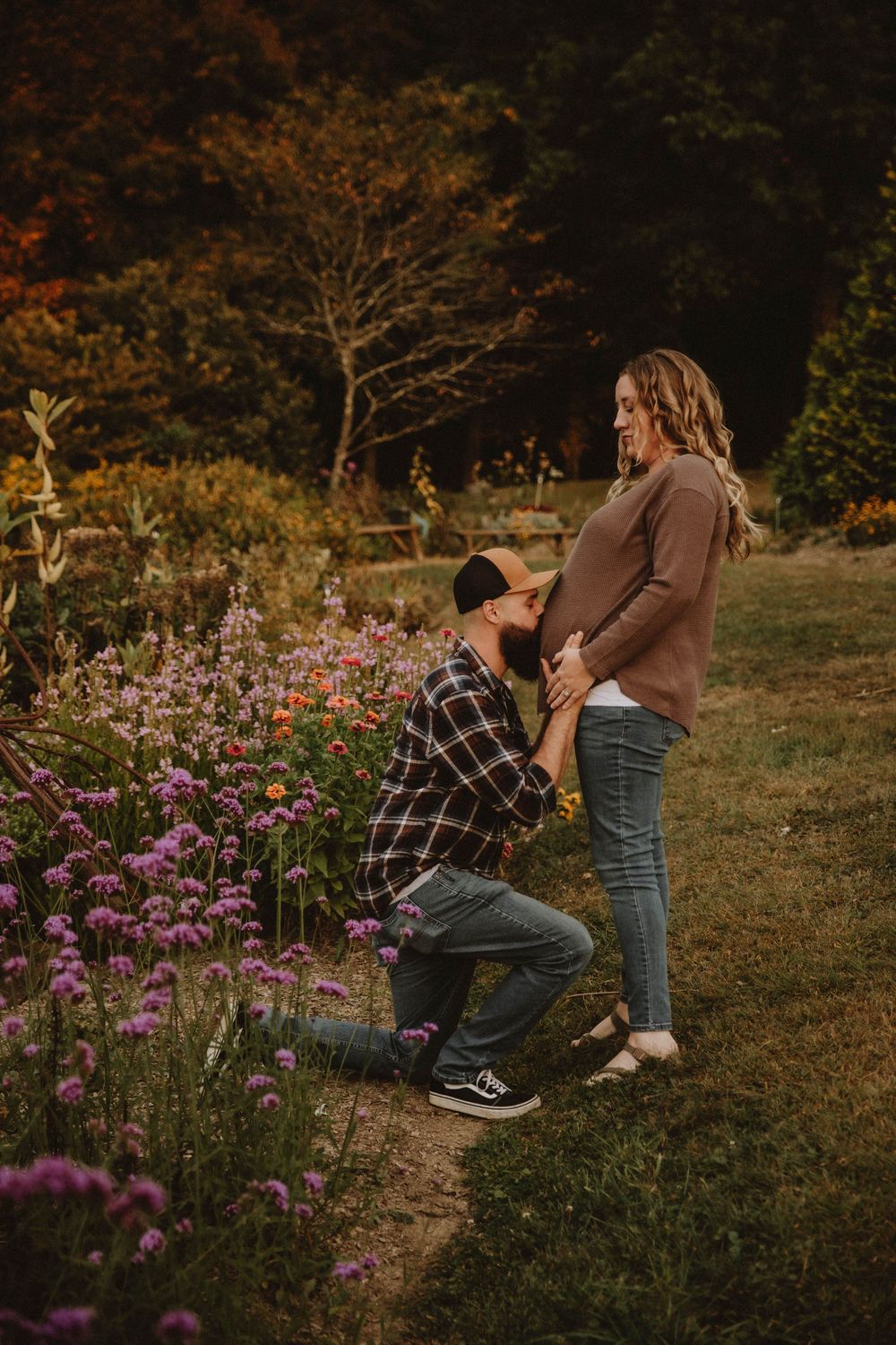 Couple shares intimate autumn maternity photo shoot in field with golden wildflowers at sunset. indiana pa photographer blue spruce park